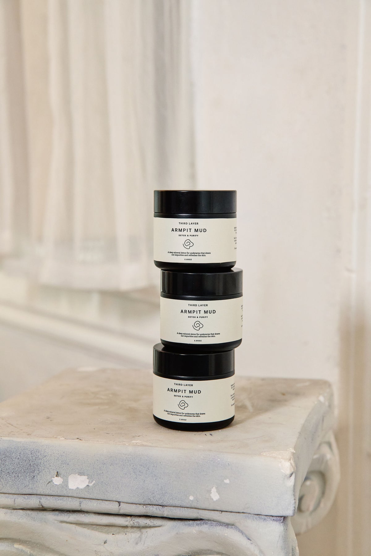 Three stacked jars of Armpit Mud